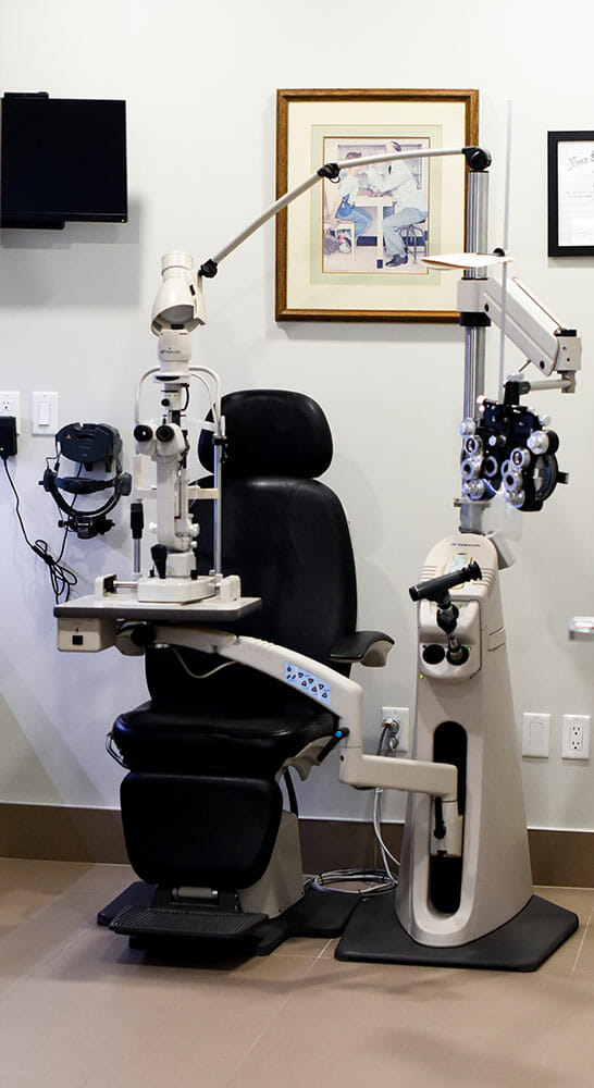 Eye exam equipment next to patient chair
